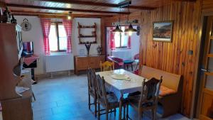 a kitchen and dining room with a table and chairs at Chalupa U Karla in Arnoltice u Decina