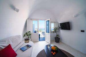 a living room with a white couch and a table at Santonero in Akrotiri