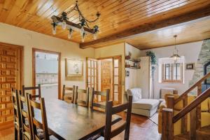 a kitchen and dining room with a wooden ceiling at Casa Rural Arix by Cardi Suites in Sallent de Gállego