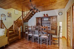 a dining room with a table and wooden stairs at Casa Rural Arix by Cardi Suites in Sallent de Gállego
