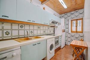 a kitchen with a sink and a dishwasher at Casa Rural Arix by Cardi Suites in Sallent de Gállego