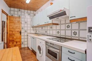 a kitchen with a sink and a stove top oven at Casa Rural Arix by Cardi Suites in Sallent de Gállego +12 photos
