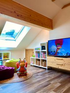 a living room with a large flat screen tv at Apartment Schönwetter in Großsölk
