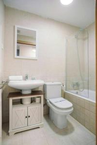 a bathroom with a toilet and a sink and a shower at LINA by Cardi Suites in Escarrilla
