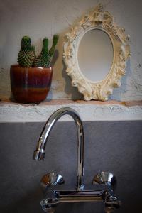 a bathroom sink with a mirror and a faucet at Bed and Breakfast 'Op de Kleijne Hei' in Well +96 photos