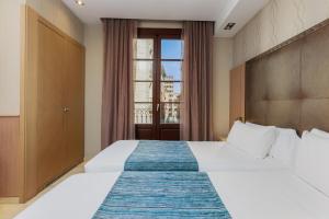 Posteľ alebo postele v izbe v ubytovaní Hotel Gótico