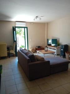 a living room with a couch and a table at Sunday Villa in Agios Georgios