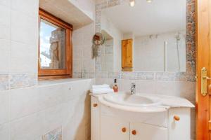 a bathroom with a sink and a mirror at Cantal by Cardi Suites in Sallent de Gállego +32 photos