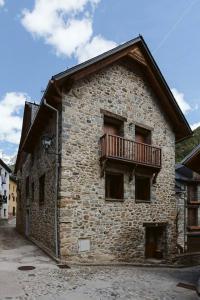 a building with a balcony on the side of it at Cantal by Cardi Suites in Sallent de Gállego