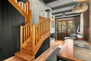 a room with a wooden staircase in a house at Iraida - Precioso dúplex en Lanuza by Cardi Suites in Lanuza