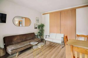 a living room with a couch and a table at La Casita del Arbol by Cardi Suites in Sallent de Gállego