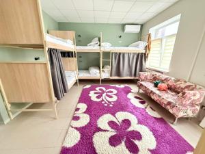 a room with a purple rug and bunk beds at Хостел Vibe Place in Dnipro