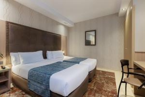 Posteľ alebo postele v izbe v ubytovaní Hotel Gótico