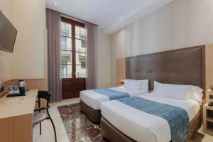 Posteľ alebo postele v izbe v ubytovaní Hotel Gótico