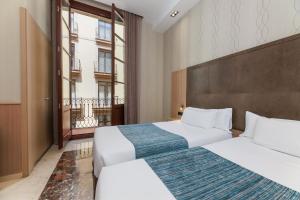 Posteľ alebo postele v izbe v ubytovaní Hotel Gótico