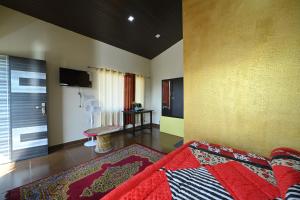 a living room with a bed and a television at Shaantvan Homestay-Near Bhalughar Waterfall-Mukteshwar in Mukteswar +38 photos