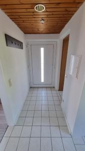 a room with a garage with a door and a ceiling at Fewo Linda - Gemütliche Ferienwohnung in direkter Bodenseenähe in Kressbronn am Bodensee