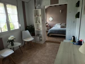 a bedroom with a bed and a mirror in a room at Chambres d'hôtes des Bruyères in Collemiers +27 photos