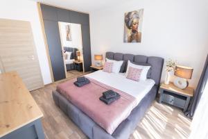 a bedroom with a large bed with two pillows on it at Azur Pearl by RV Apartments in Saints Constantine and Helena
