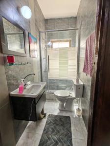 a bathroom with a sink and a toilet at Khalda One Bedroom Apt in Amman +10 photos