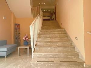 a staircase in a living room with a blue couch at Hotel Residence Ponente in Cesenatico