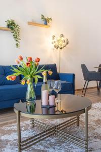 a living room with a blue couch and a coffee table at Azur Pearl by RV Apartments in St. St. Constantine and Helena