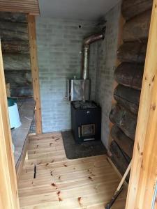 an inside view of a room with a wood stove at Nivan Majoitus in Joensuu