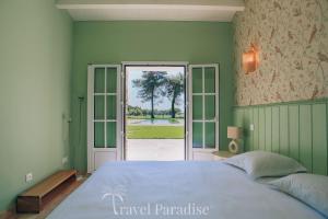 a bedroom with a large bed and an open door at Villa du Golf in Les Portes +58 photos