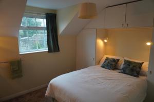 a bedroom with a bed with two pillows and a window at Atlantic Lodge in Ballyshannon
