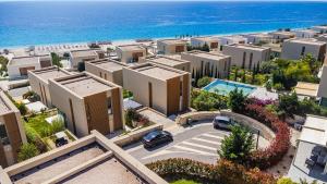 an aerial view of a city with buildings and the ocean at The Ionian Villa Green Coast in Himare