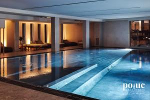 a large swimming pool in a hotel room at Rêve Blanc - Poluc Apartments bilocale in Champoluc +12 photos