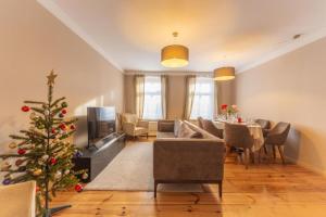a living room with a christmas tree and a couch at Lux Central Apartment in Berlin