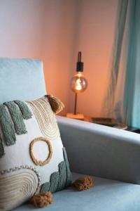 a pillow sitting on a bed next to a lamp at Garbo by Cardi Suites in Formigal +18 photos