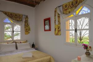 Postel nebo postele na pokoji v ubytování Aura Retreat