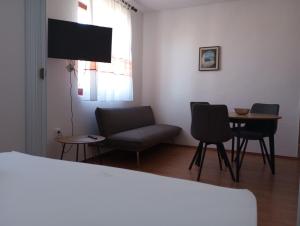 a living room with a couch and chairs and a table at villa Adriana apartments in Rab