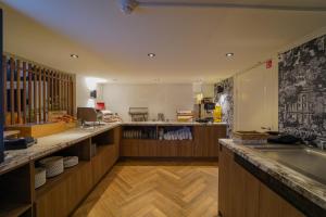 a kitchen with a counter with a sink in it at De oude gevangenis Almelo in Almelo