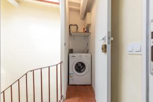 a laundry room with a washing machine in a hallway at Merceria 4 by Unik Vacation in Tarragona +44 photos