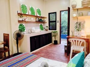 a living room with a bed and a sink and a desk at Amwani Azure in Puerto Princesa City +63 photos