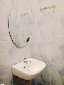 a bathroom with a sink and a mirror at Amwani Azure in Puerto Princesa City
