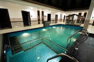 a large swimming pool in a building at Hotel Navil Exotica in Chicalim