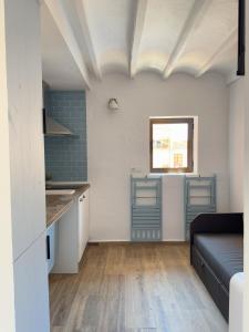 a kitchen and a living room with a couch at Bobal - Harbor's Light in Villajoyosa +4 photos