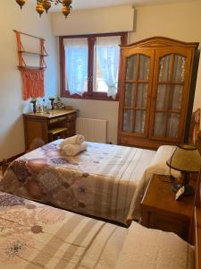a bedroom with two beds and a table and a window at Montes de Alhama Il in Soria +3 photos