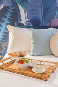 a tray of food on a bed with a tray of food at Rezia Apartments by Rent All Como in Como