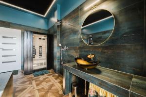 a bathroom with a sink and a mirror at Blue House SPA & JACUZZI Poznań in Poznań +18 photos