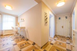 a hallway with a table and chairs in a room at Lux Central Apartment in Berlin +127 photos