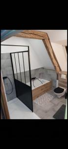 a room with a bath tub and a sink at Le clos Saint Vincent in Manneville-ès-Plains