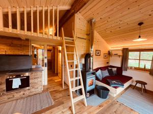 a loft bed in a tiny house at Chalet Herbst in Lofer +16 photos