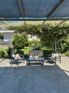 a patio with two chairs and a table with at Country House Nannos in Néa Thésis