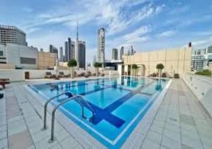 a large swimming pool on top of a building at Bay Square studio Bay view in Dubai