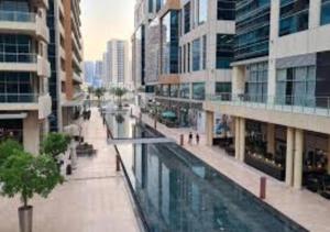 an empty street in a city with buildings and a canal at Bay Square studio Bay view in Dubai
